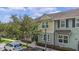 Attractive townhome showcasing a colorful facade, neat landscaping, and convenient parking, offering comfortable living at 1349 Mill Stream Ln, Winter Springs, FL 32708