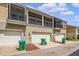 Townhome exterior with garage doors, screened patios, and lush landscaping in front at 1349 Mill Stream Ln, Winter Springs, FL 32708