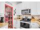 Modern kitchen boasting stainless steel appliances, granite countertops, and stylish pantry door at 1349 Mill Stream Ln, Winter Springs, FL 32708
