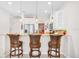 Modern kitchen with a breakfast bar, stainless steel appliances, pendant lighting, and ample cabinet space at 1349 Mill Stream Ln, Winter Springs, FL 32708