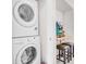 Laundry room with stackable washer and dryer with bonus game room adjacent at 1349 Mill Stream Ln, Winter Springs, FL 32708