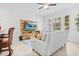 Inviting living room with large windows, modern decor, and comfortable seating, perfect for relaxation and social gatherings at 1349 Mill Stream Ln, Winter Springs, FL 32708