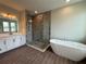 Luxurious bathroom with a glass shower and soaking tub, complemented by dual vanities at 2564 Hawks Overlook Pl, Oviedo, FL 32765