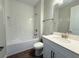 Modern bathroom featuring a tiled tub-shower combo and a sleek vanity with ample storage at 2564 Hawks Overlook Pl, Oviedo, FL 32765