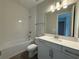 Bright bathroom with tiled tub-shower, modern fixtures, and vanity with sleek countertops at 2564 Hawks Overlook Pl, Oviedo, FL 32765