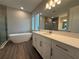 Bright bathroom features a standalone tub, double vanity with white cabinets, and sleek tile flooring at 2564 Hawks Overlook Pl, Oviedo, FL 32765