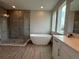 Bright, modern bathroom featuring a glass shower, soaking tub, and stylish vanity at 2564 Hawks Overlook Pl, Oviedo, FL 32765