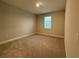 Clean bedroom with neutral walls, one window with blinds, and comfortable carpet flooring at 2564 Hawks Overlook Pl, Oviedo, FL 32765