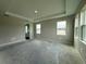 Spacious bedroom with tray ceiling and large windows allowing plenty of natural light at 2564 Hawks Overlook Pl, Oviedo, FL 32765