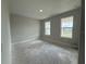 Neutral bedroom providing natural light from two windows and a calming, spacious feel at 2564 Hawks Overlook Pl, Oviedo, FL 32765