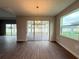 Elegant dining room with wood-look tile flooring and sliding glass doors to the lanai at 2564 Hawks Overlook Pl, Oviedo, FL 32765