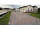 Beautiful exterior view with three-car garage and paved driveway at 2564 Hawks Overlook Pl, Oviedo, FL 32765