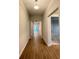 Inviting hallway with wood-look tile flooring and neutral paint leads to an open-concept living area at 2564 Hawks Overlook Pl, Oviedo, FL 32765