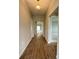 Inviting hallway featuring wood-look floors leading to bright, open living spaces at 2564 Hawks Overlook Pl, Oviedo, FL 32765
