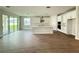 Contemporary kitchen featuring stainless hood, white cabinets, island and sliding doors at 2564 Hawks Overlook Pl, Oviedo, FL 32765