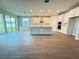Open-concept kitchen with a large island, stainless appliances, and wood-look flooring at 2564 Hawks Overlook Pl, Oviedo, FL 32765