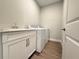 Functional laundry room features modern appliances, a sink, and built-in cabinetry for efficient space at 2564 Hawks Overlook Pl, Oviedo, FL 32765