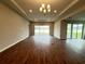 Spacious living room with wood-look flooring and a decorative tray ceiling at 2564 Hawks Overlook Pl, Oviedo, FL 32765