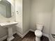 Stylish powder room with a pedestal sink, updated fixtures, and a modern toilet at 2564 Hawks Overlook Pl, Oviedo, FL 32765