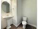 Chic powder room featuring a pedestal sink, modern faucet, and stylish lighting at 2564 Hawks Overlook Pl, Oviedo, FL 32765