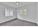 Sunlit room with neutral carpet, two windows for natural light, and fresh white walls at 1322 Susannah Blvd, Orlando, FL 32803