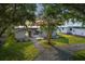 Charming home with manicured lawn, mature trees and gravel driveway at 1322 Susannah Blvd, Orlando, FL 32803