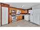 Functional kitchen with wooden cabinets, a black dishwasher and a white refrigerator at 1322 Susannah Blvd, Orlando, FL 32803