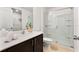 Modern bathroom with a glass shower and dark vanity at 365 Gardenia Ct, Poinciana, FL 34759