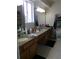Spacious bathroom featuring double sinks with granite countertops and ample cabinet space at 2618 Coventry Ln, Ocoee, FL 34761
