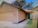 Welcoming home featuring an attached garage, freshly painted trim, and an inviting front entrance at 2618 Coventry Ln, Ocoee, FL 34761