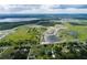 Aerial view of a new housing development with lake and surrounding farm land at 2637 Great Heron Ave, Saint Cloud, FL 34773