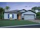 New home with blue shutters and two-car garage at 2637 Great Heron Ave, Saint Cloud, FL 34773