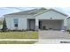 New construction home with a two-car garage and landscaped lawn at 2637 Great Heron Ave, Saint Cloud, FL 34773