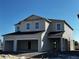 Newly constructed two-story home with a three-car garage, a covered porch, and ample natural light from large windows at 2655 Great Heron Ave, Saint Cloud, FL 34773