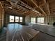 Interior view showcasing the wooden frame construction with exposed beams and ductwork and multiple windows at 2684 Great Heron Ave, Saint Cloud, FL 34773