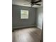 Bedroom featuring wood-look flooring, a ceiling fan, and natural light at 3505 Pine Ridge Ct, Orlando, FL 32808