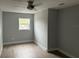 This bedroom features hardwood flooring, a ceiling fan, fresh paint and a window at 3505 Pine Ridge Ct, Orlando, FL 32808