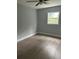 Bedroom features ceiling fan, wood-look flooring, window, and neutral paint at 3505 Pine Ridge Ct, Orlando, FL 32808