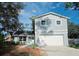 Two-story house featuring a white garage door, and trimmed front lawn with minimal foliage and a partially shaded yard at 3505 Pine Ridge Ct, Orlando, FL 32808