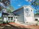 Two-story house featuring a white garage door, and trimmed front lawn with minimal foliage and a partially shaded yard at 3505 Pine Ridge Ct, Orlando, FL 32808