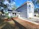 An eye-level shot of a light blue house with a white garage door, and partial landscape at 3505 Pine Ridge Ct, Orlando, FL 32808