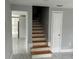 Entryway featuring new marble floors with a view to the updated kitchen and a view of the wooden stairs at 3505 Pine Ridge Ct, Orlando, FL 32808