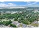 Expansive aerial view showcases the neighborhood, nearby lake, and lush greenery at 500 N 13Th St, Leesburg, FL 34748