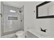 Modern bathroom featuring a tiled shower with black fixtures and a sleek vanity at 500 N 13Th St, Leesburg, FL 34748