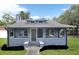 Charming single Gathering home featuring a covered front porch and a well-maintained, grassy lawn at 500 N 13Th St, Leesburg, FL 34748