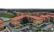 Community aerial view showing terracotta roofs, ample parking, and beautiful landscaping at 907 Charo Pkwy # 923, Davenport, FL 33897