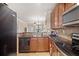 Kitchen area showcasing stainless steel appliances and dark granite countertops at 907 Charo Pkwy # 923, Davenport, FL 33897