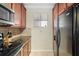 Galley kitchen featuring stainless steel appliances and wood cabinets at 907 Charo Pkwy # 923, Davenport, FL 33897