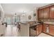 Kitchen leading to living space showcasing breakfast bar and stainless appliances at 907 Charo Pkwy # 923, Davenport, FL 33897