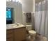 Clean bathroom with a shower curtain, toilet, towels, and a vanity with sink at 13500 Turtle Marsh Loop # 823, Orlando, FL 32837